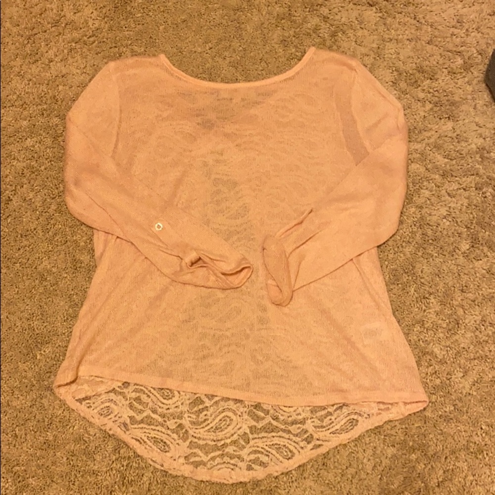 pink sweater with lace detailing in the back